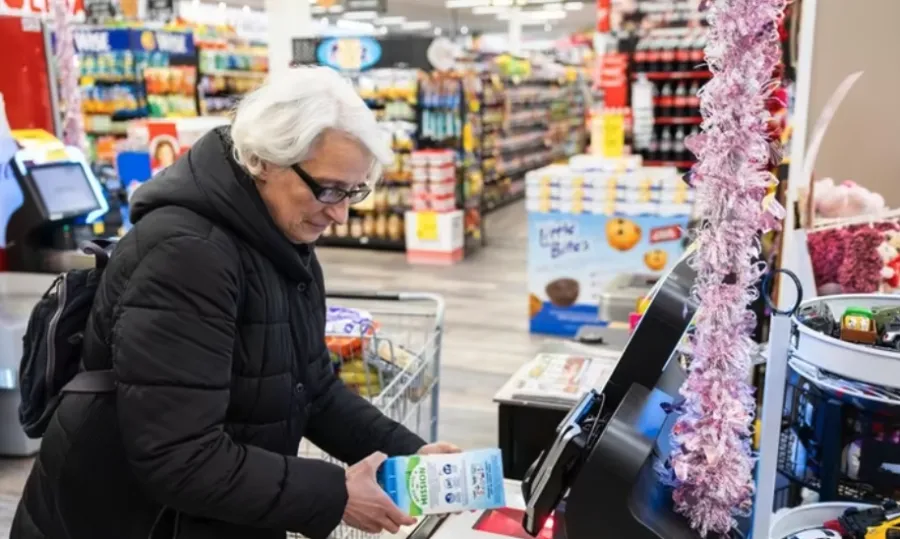 Franklin Square resident Ana Gioia uses a self-checkout register at the Holiday Farms supermarket in Franklin Square. Credit: Corey Sipkin